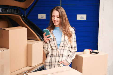 woman on her phone with storage boxes